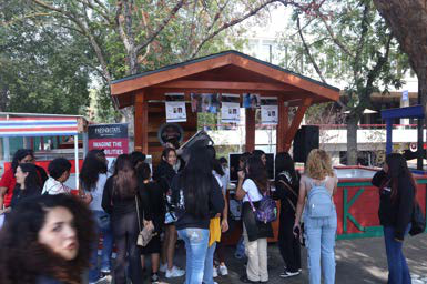 students standing at the president's booth