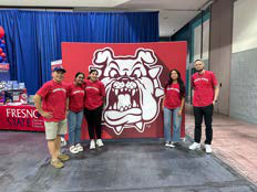 students standing in front of a poster