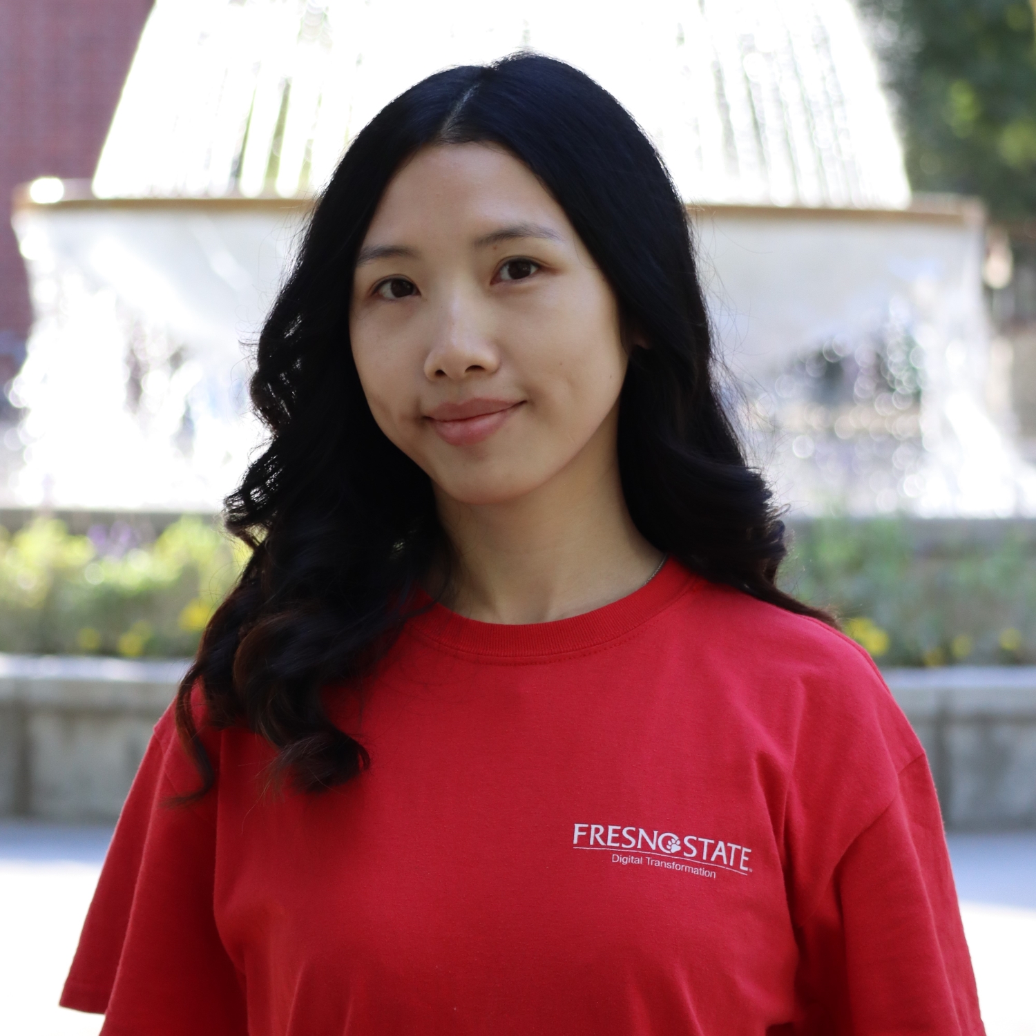 headshot of Angela infront of the fountain