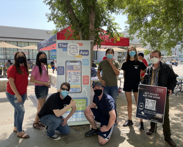 group photo of dxihub member infront of the bulldog genie banner