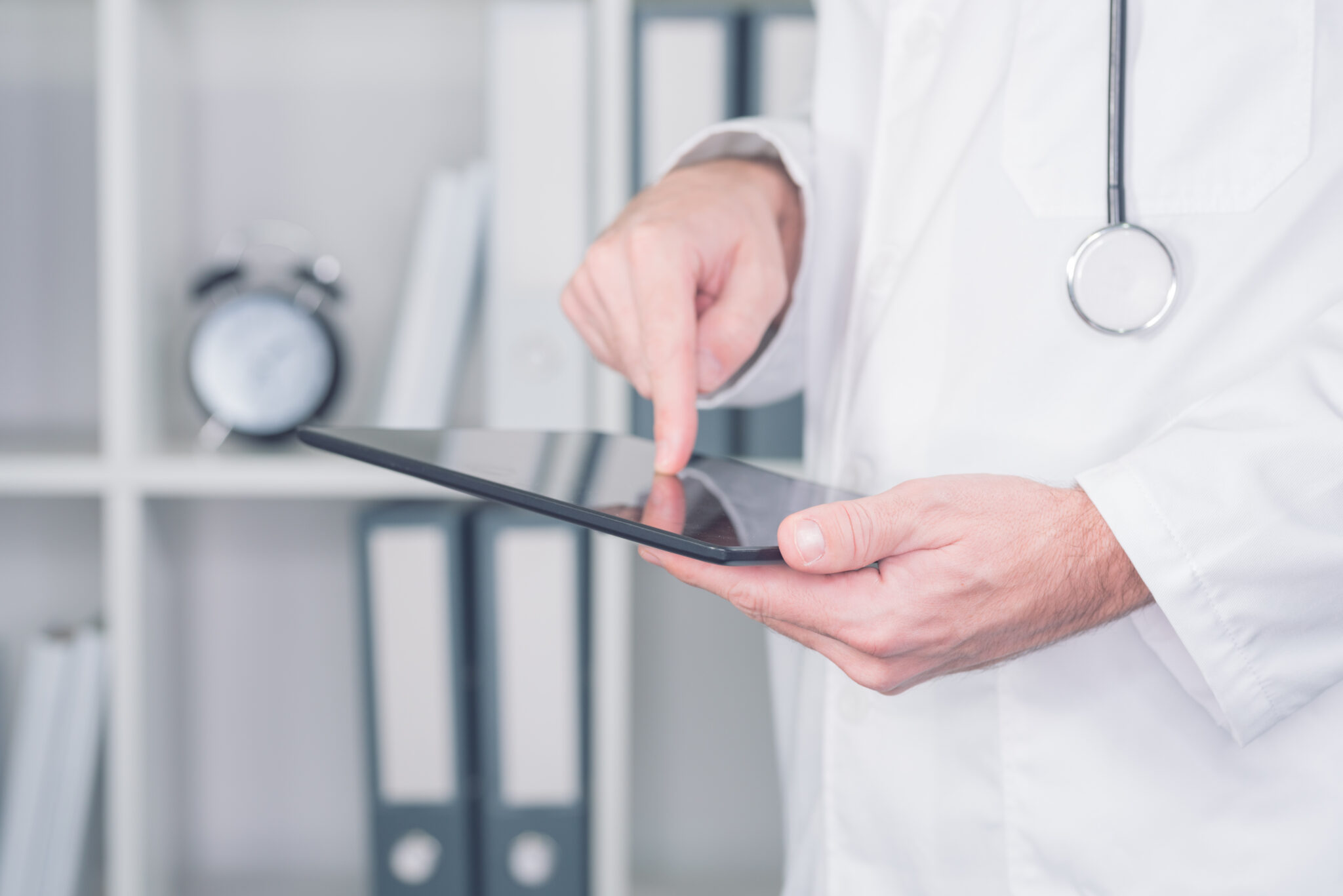 cropped photo of a doctor using a tablet