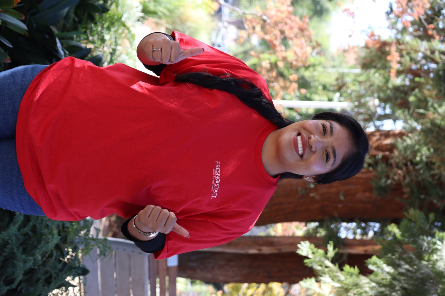 headshot of Yamileth smiling and hands in front of her holding two thumbs up!