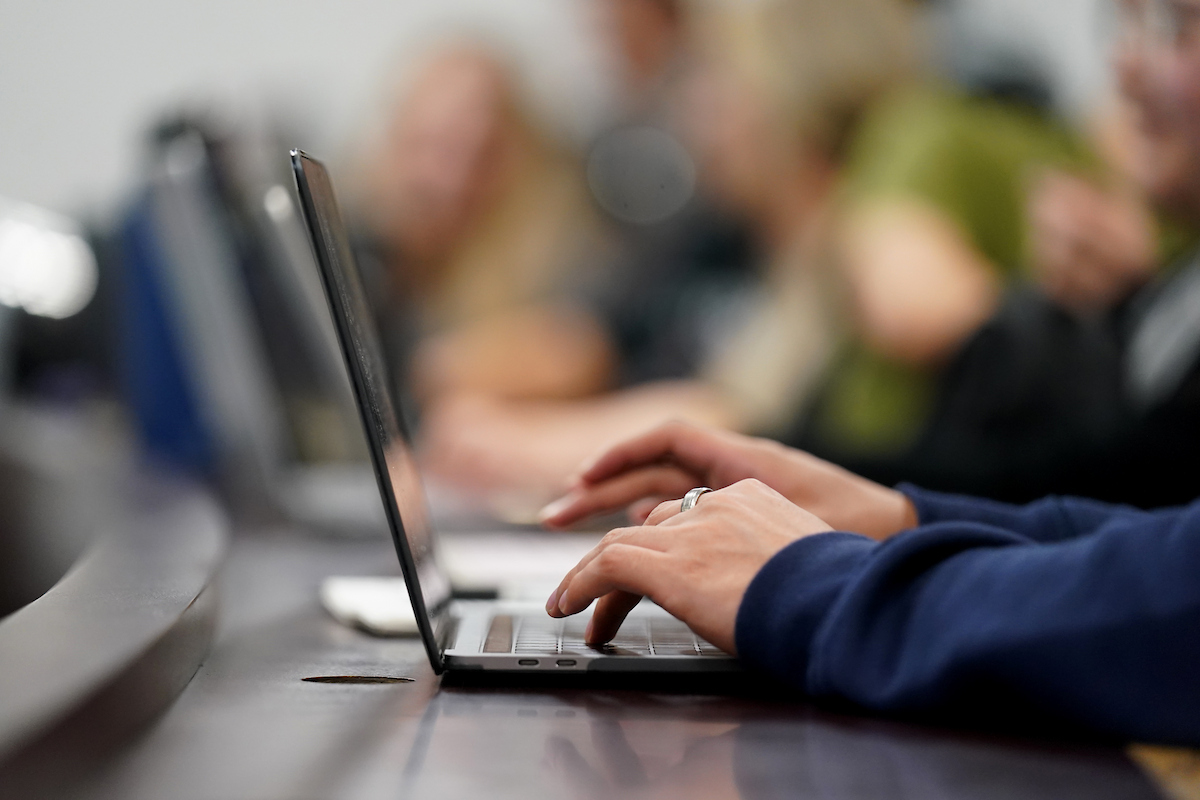 hands typing on laptop